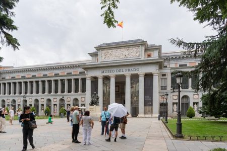Guided tour group exploring masterpieces at the Prado Museum in Madrid.